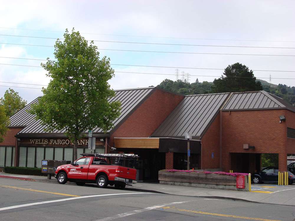 metal-roof-on-brick-commercial-building Replacement standing seam metal roof on a commercial building