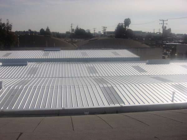 New fiberglass skylights and ridge vents installed with new metal roofing